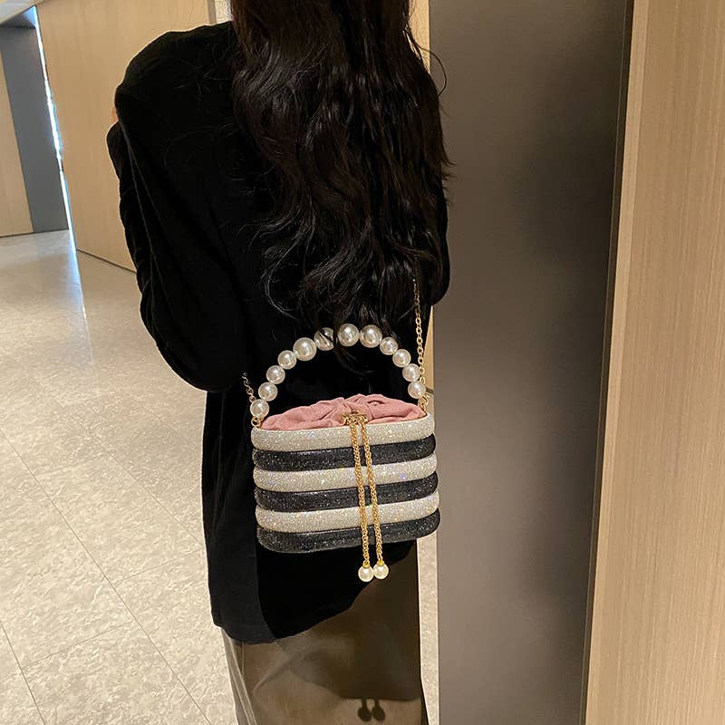 Slung over a pearl sparkling handbag