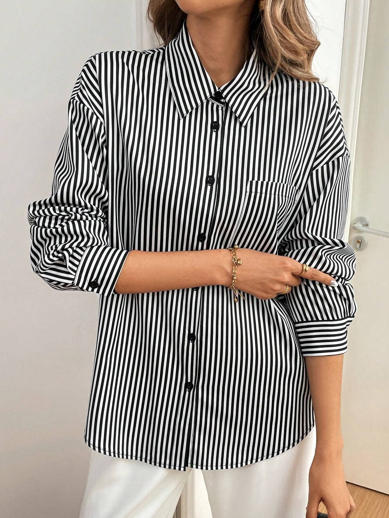 A striped printed long-sleeved shirt with a bow