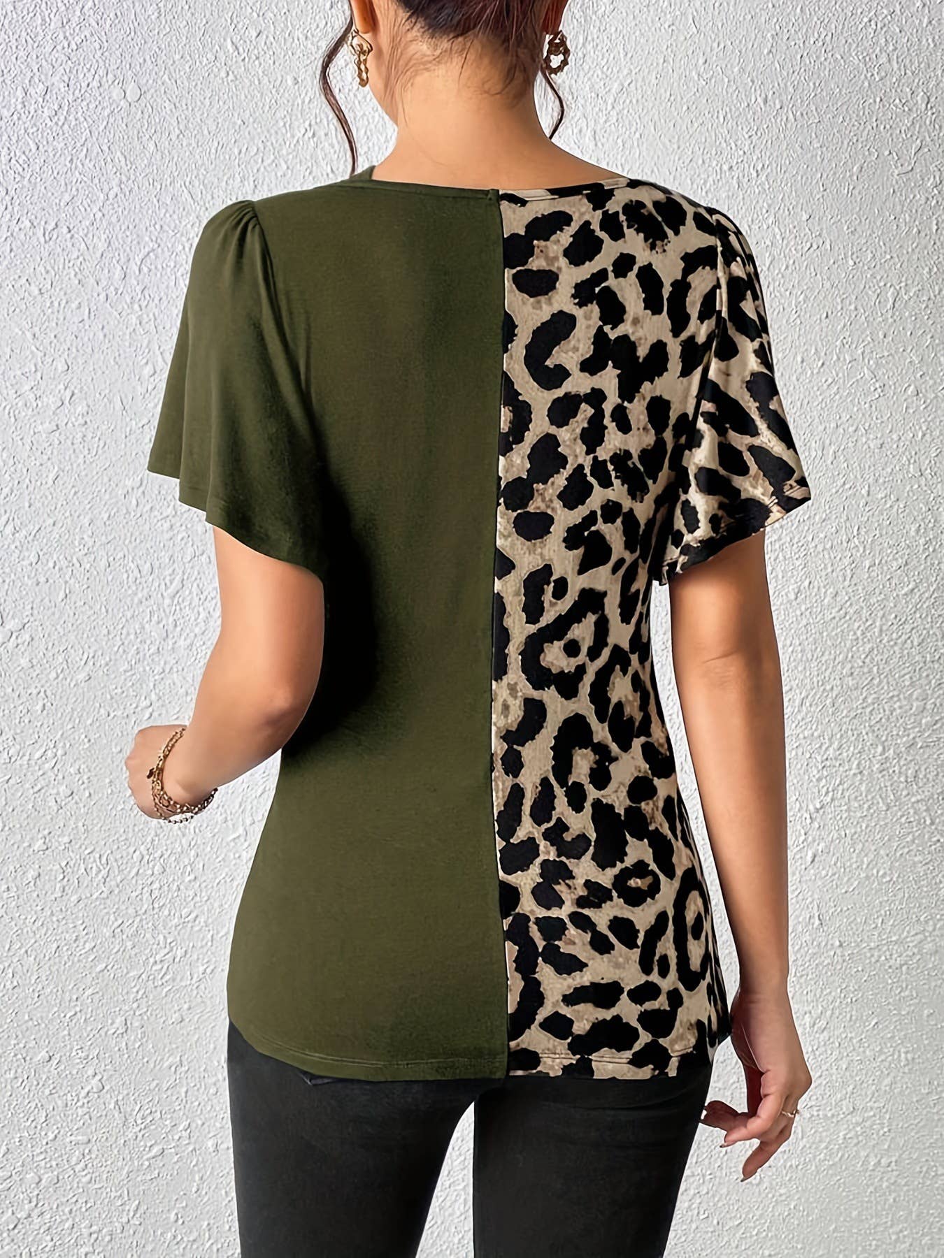 A leopard print asymmetrical collar patchwork top