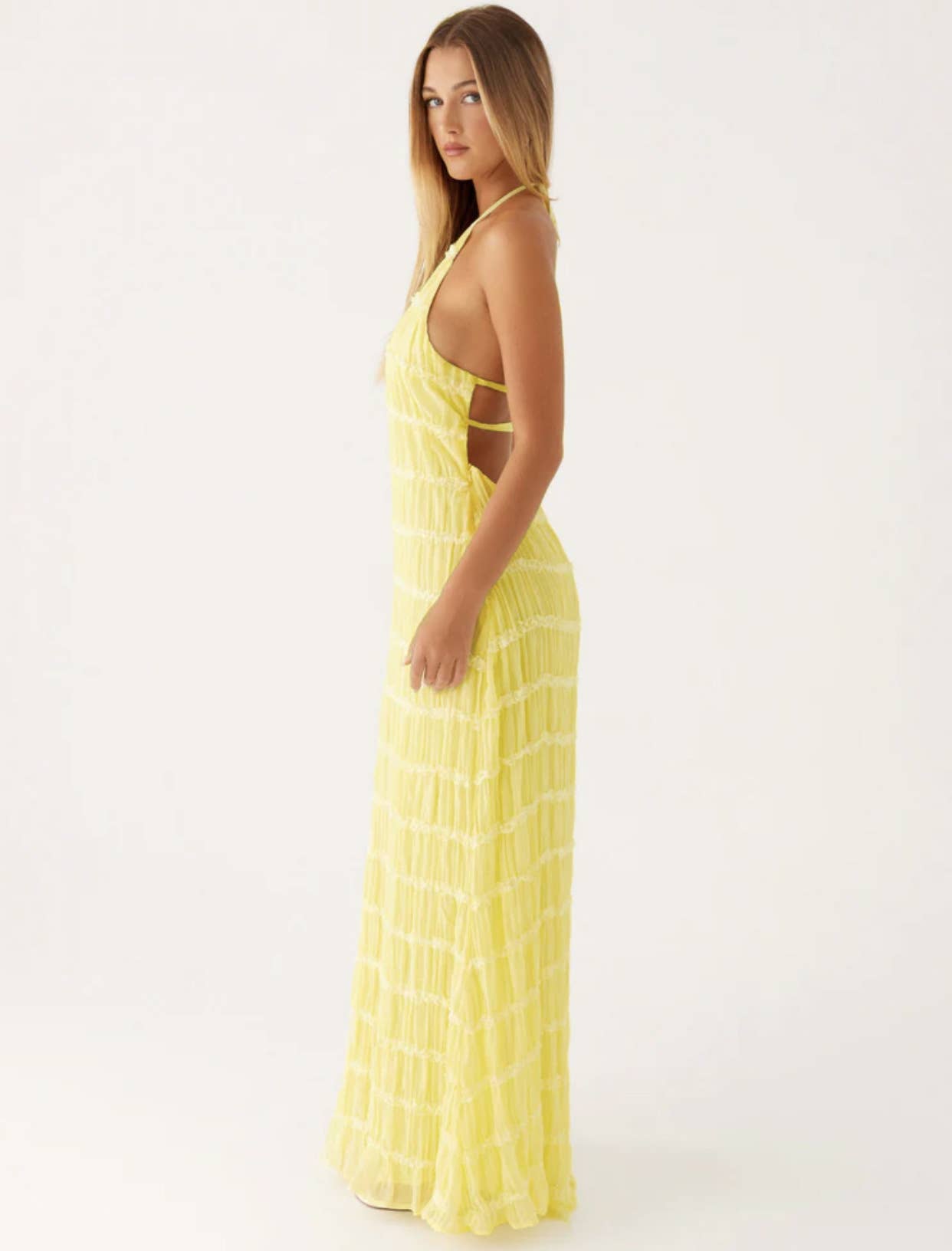 A long dress with a halter strap and pleated lace