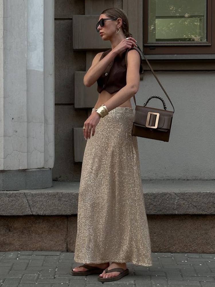 A long straight skirt in golden thread sequins