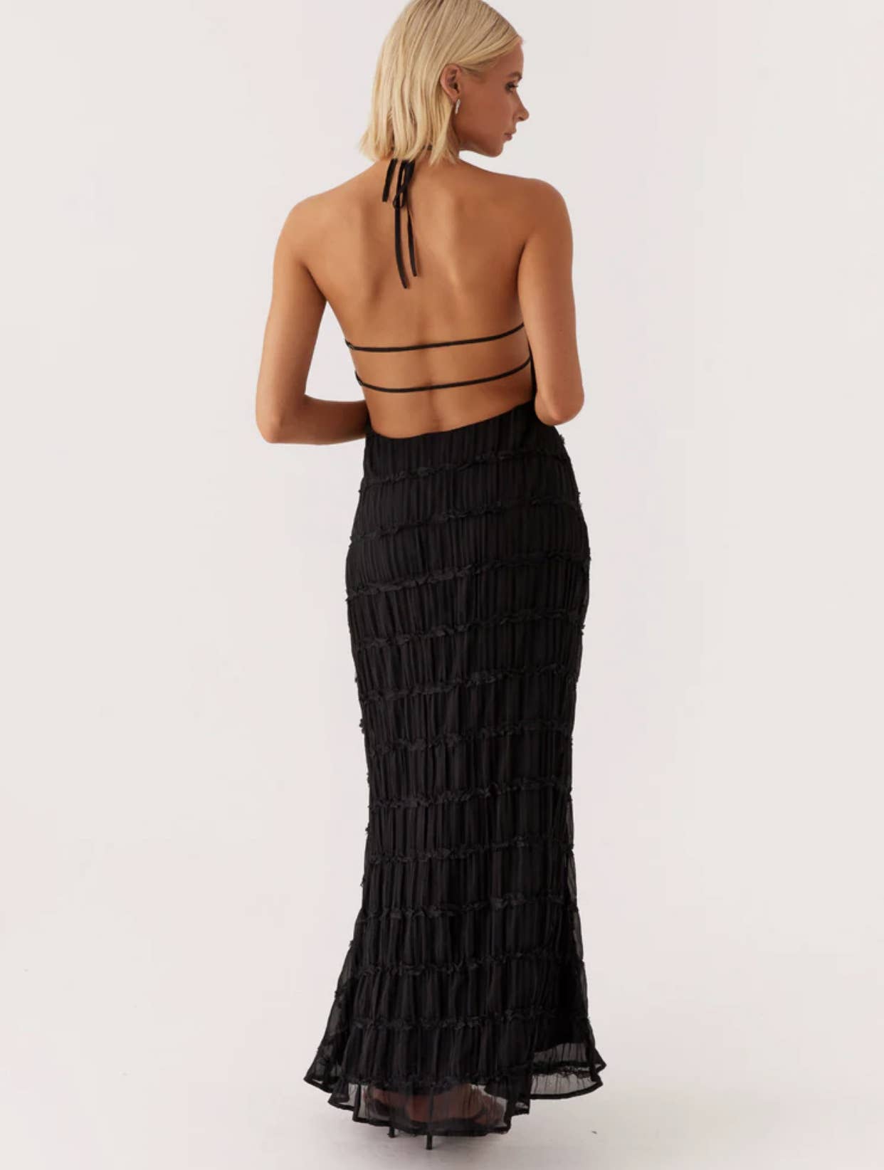 A long dress with a halter strap and pleated lace