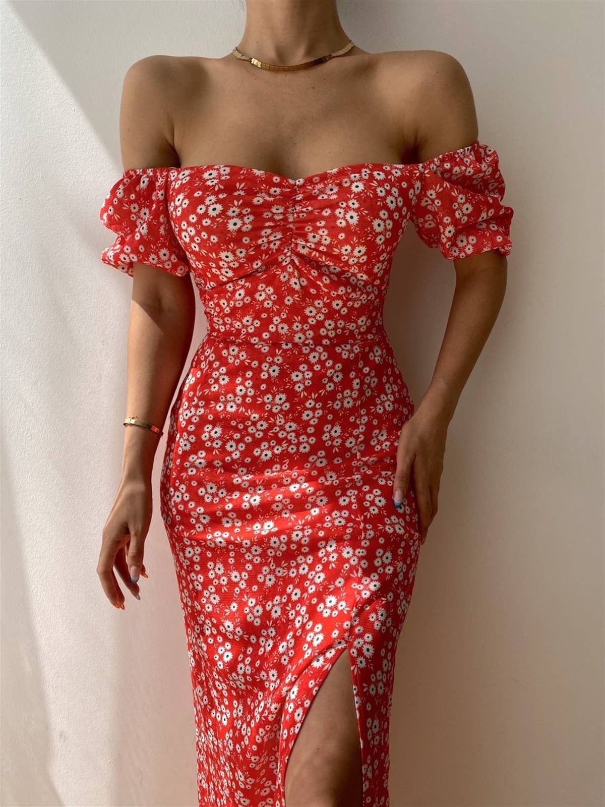 A floral off-shoulder pleated body-hugging dress
