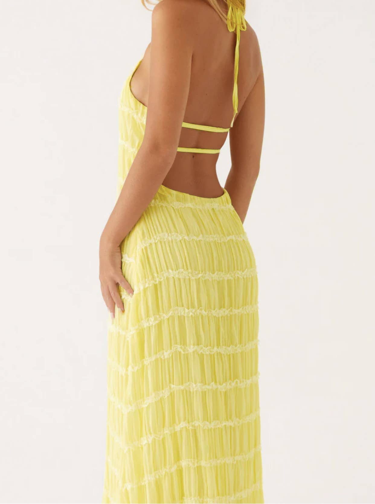 A long dress with a halter strap and pleated lace