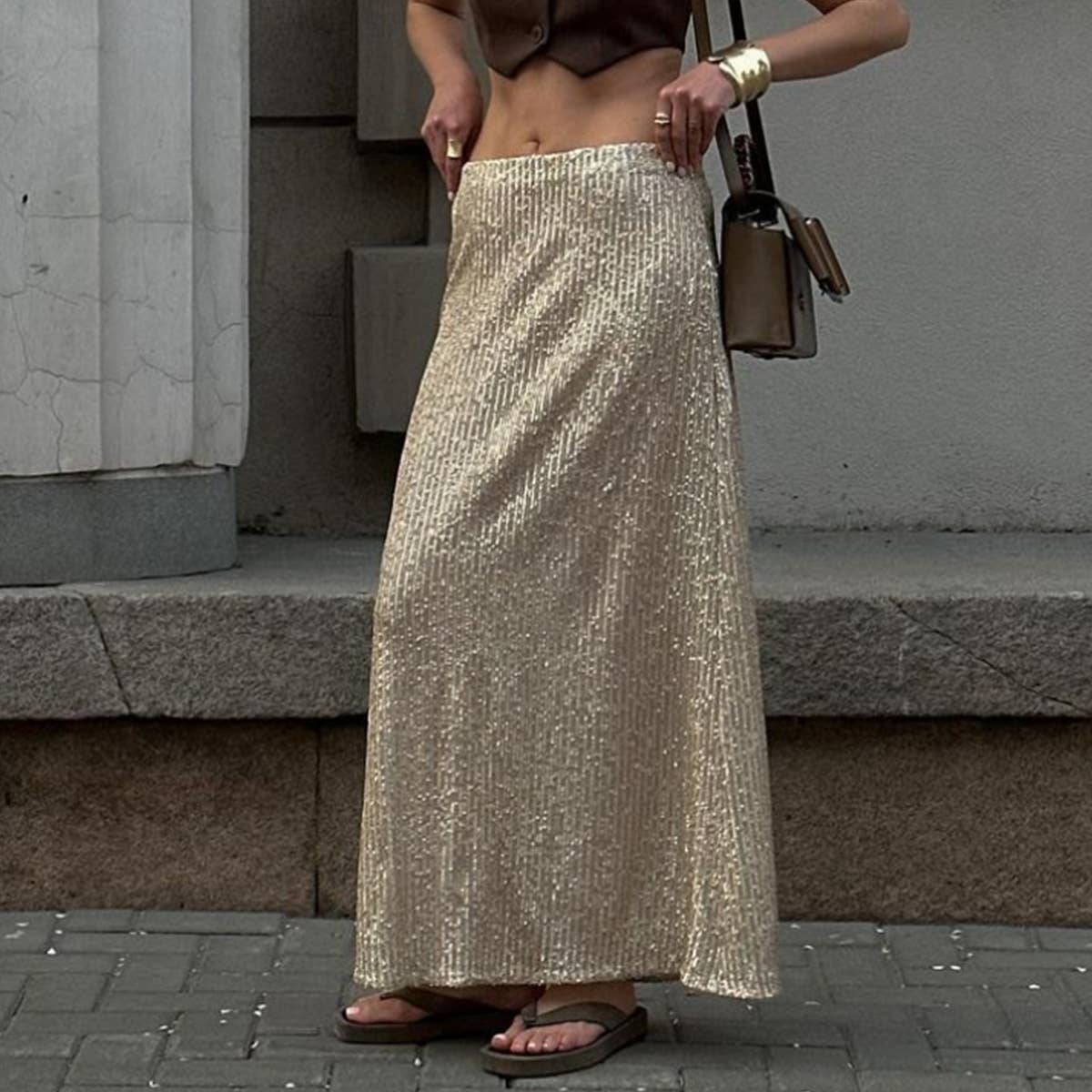 A long straight skirt in golden thread sequins