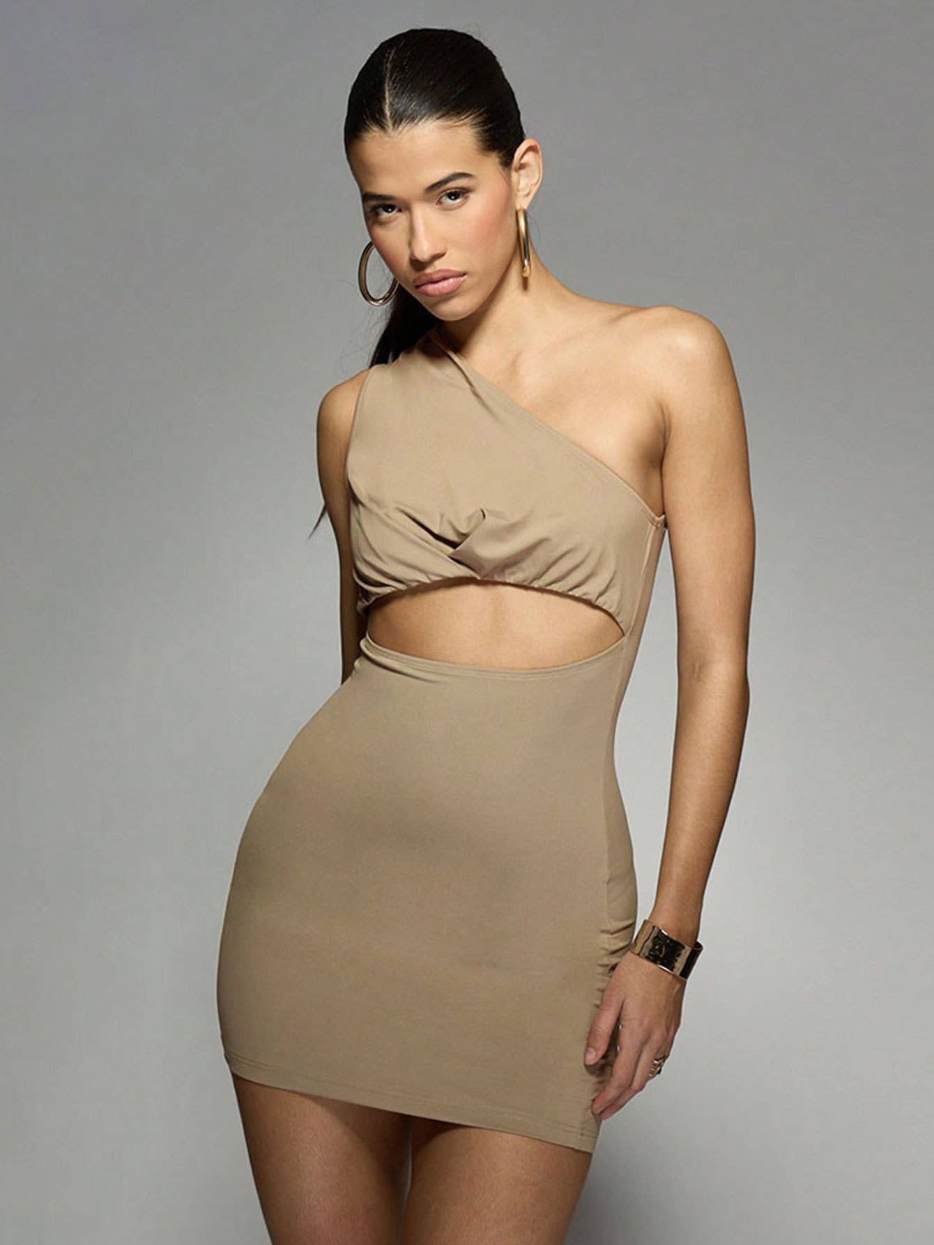 A solid color dress with sloping neck and midriff