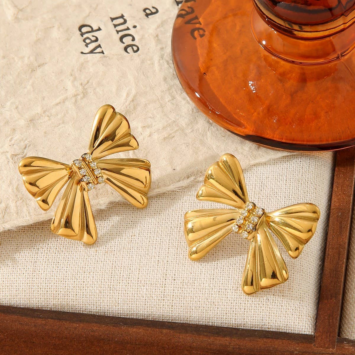 TITANIUM STEEL BOW EARRINGS INLAID WITH RHINESTONES