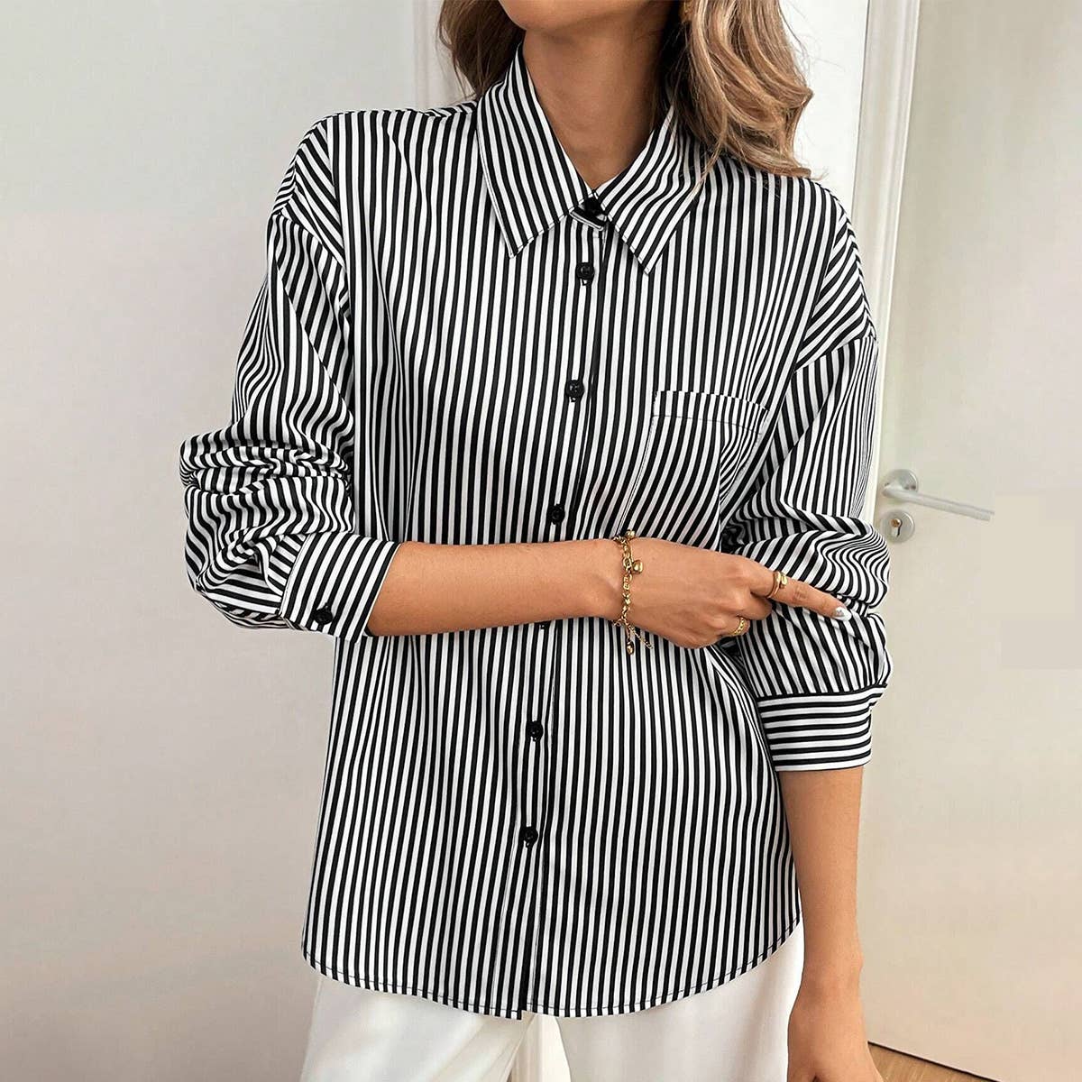 A striped printed long-sleeved shirt with a bow