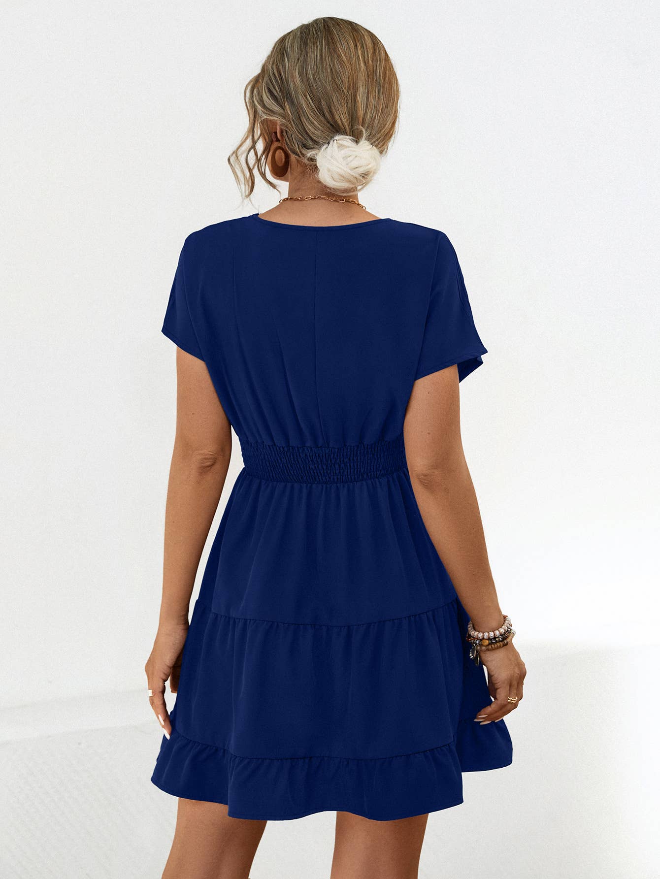 A V-neck solid color cinched short dress