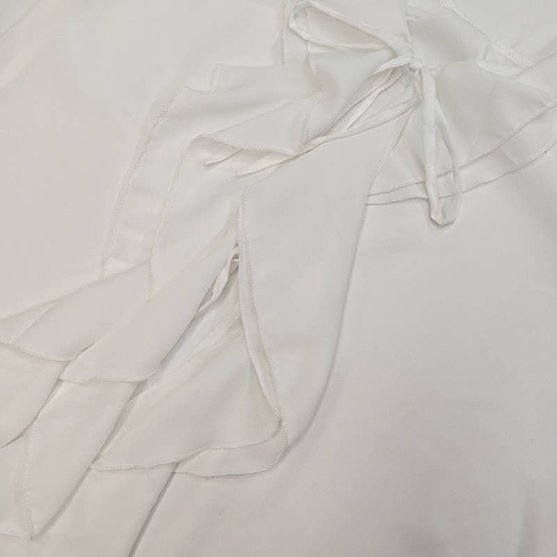 A stylish lace-up design with ruffled cardigan