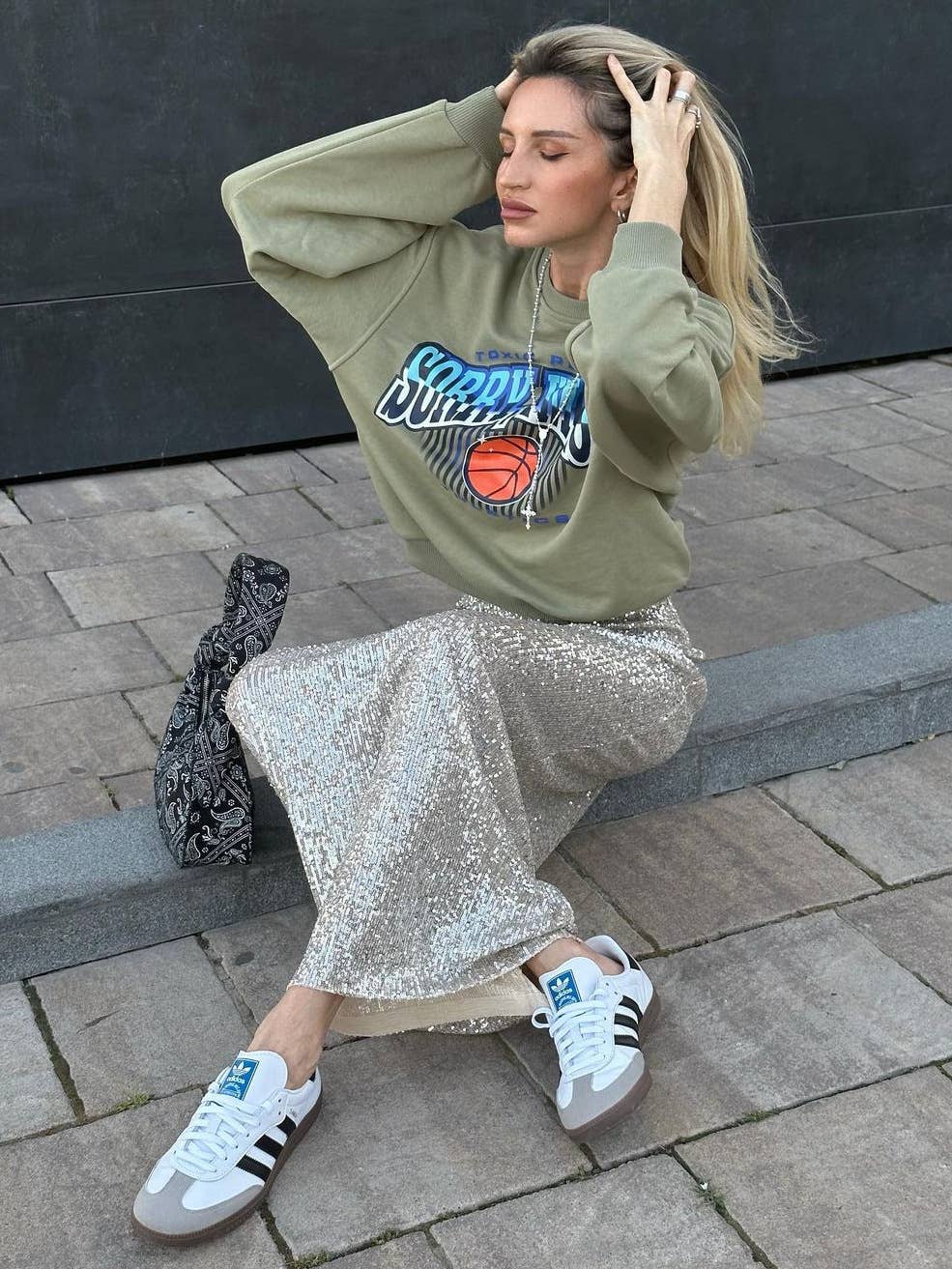 A long straight skirt in golden thread sequins