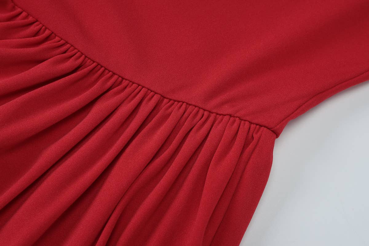 A halter, backless, high-waisted pleated dress