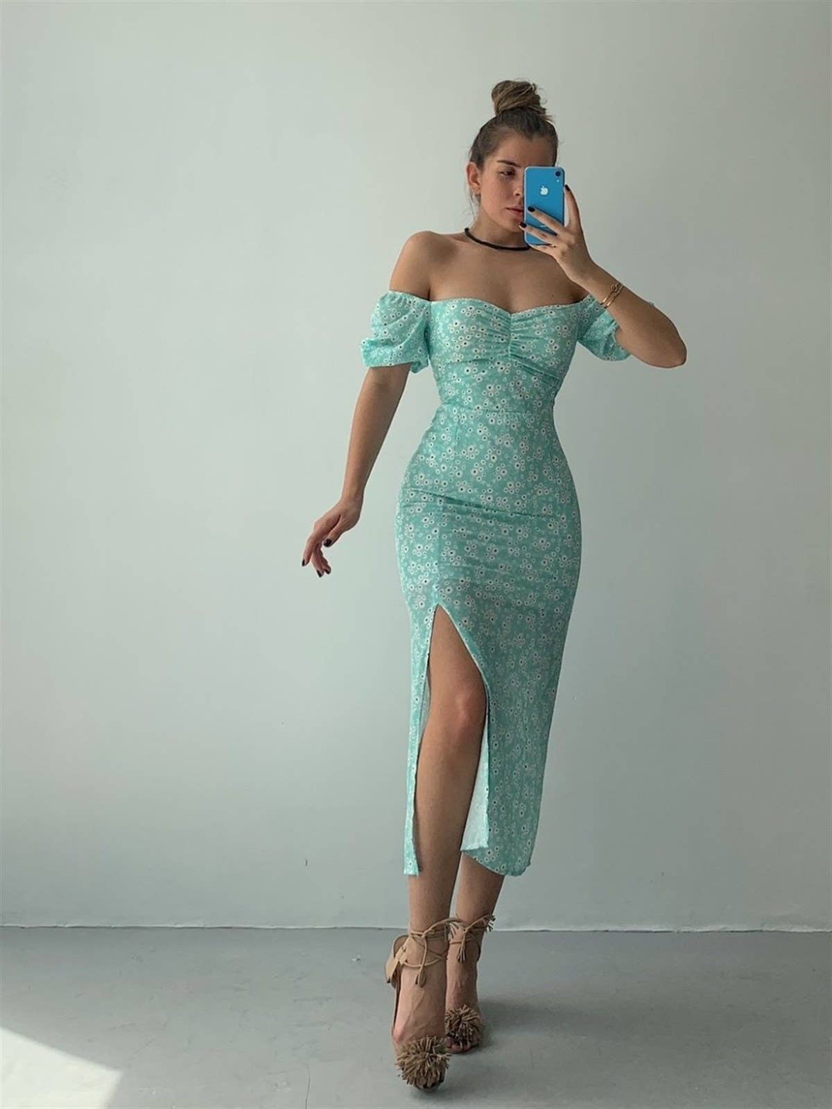 A floral off-shoulder pleated body-hugging dress