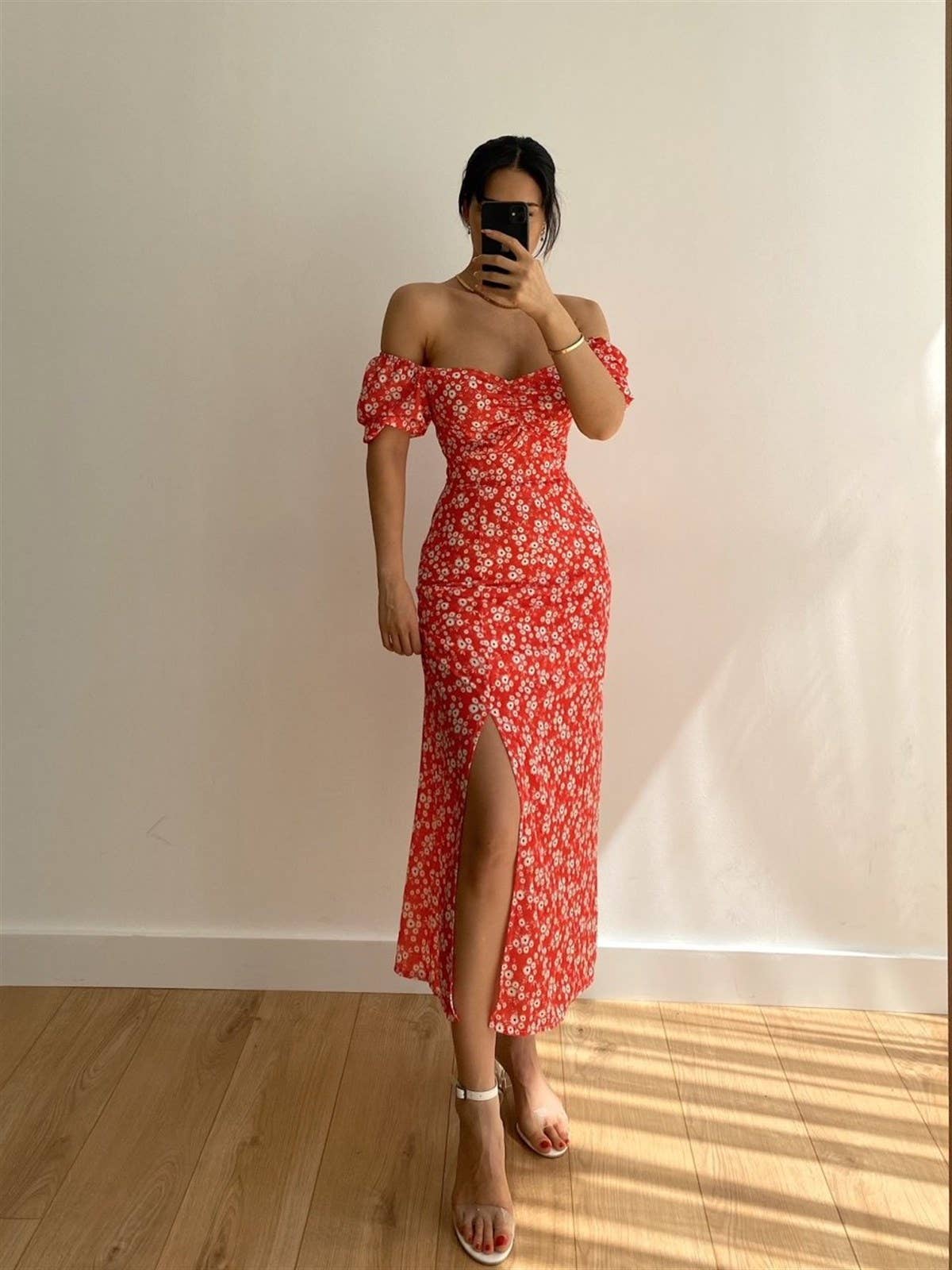 A floral off-shoulder pleated body-hugging dress