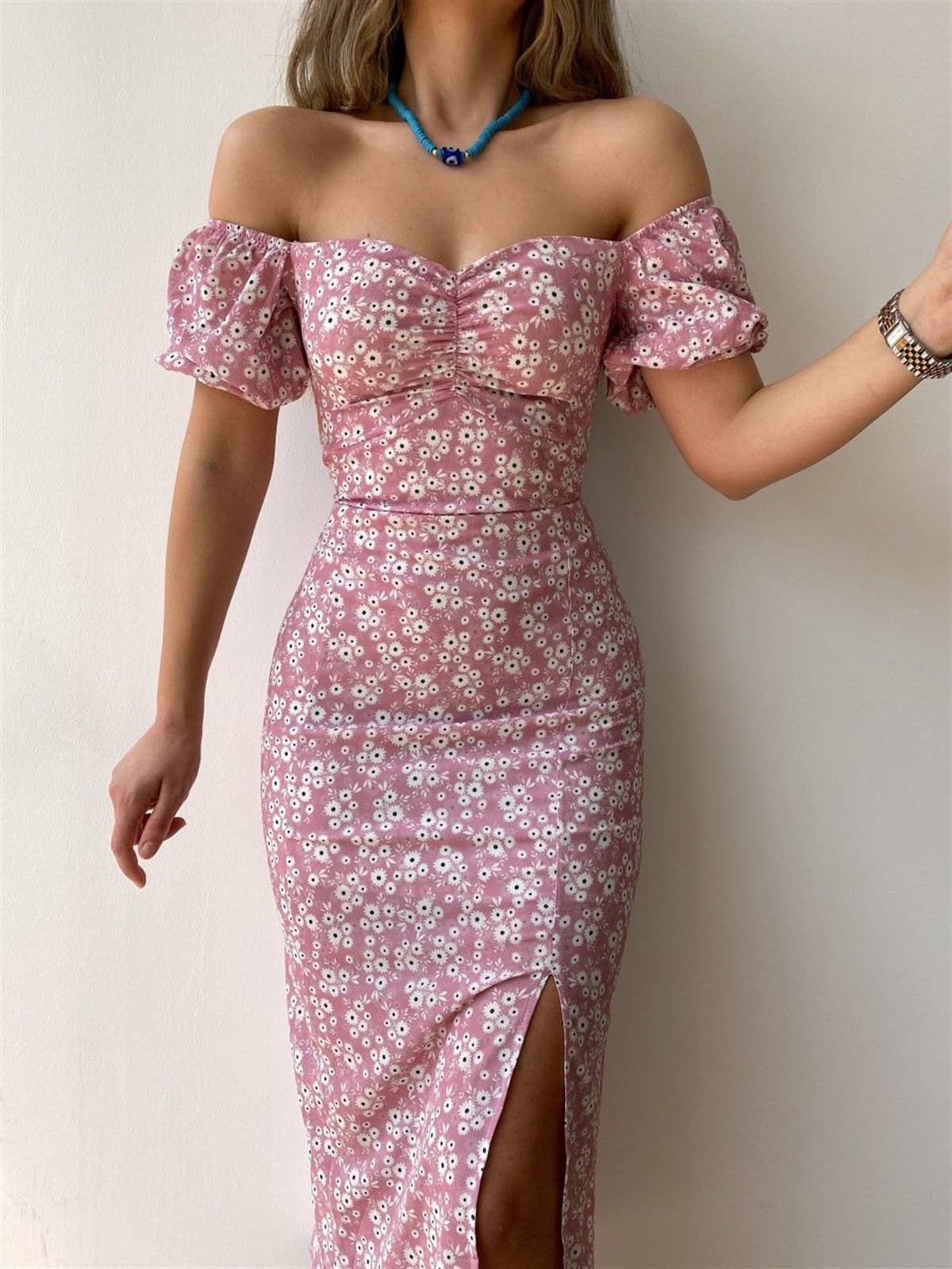 A floral off-shoulder pleated body-hugging dress