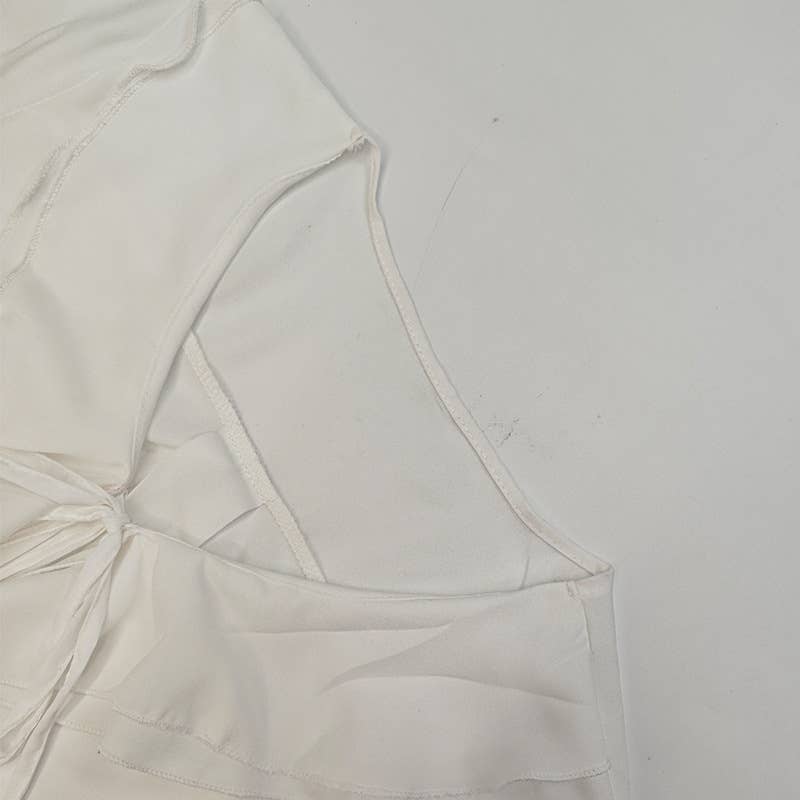 A stylish lace-up design with ruffled cardigan